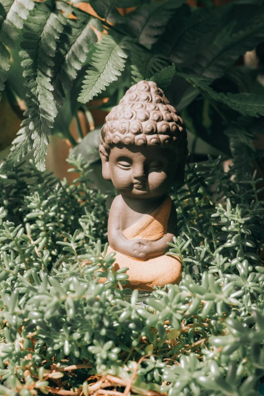 a statue sitting on top of a lush green field