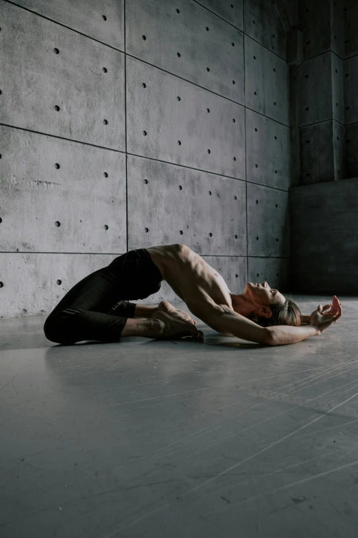 a man lying on the ground wearing black tights