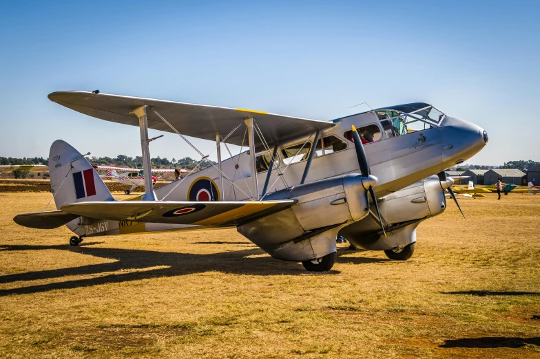 the old airplane is parked in the grass