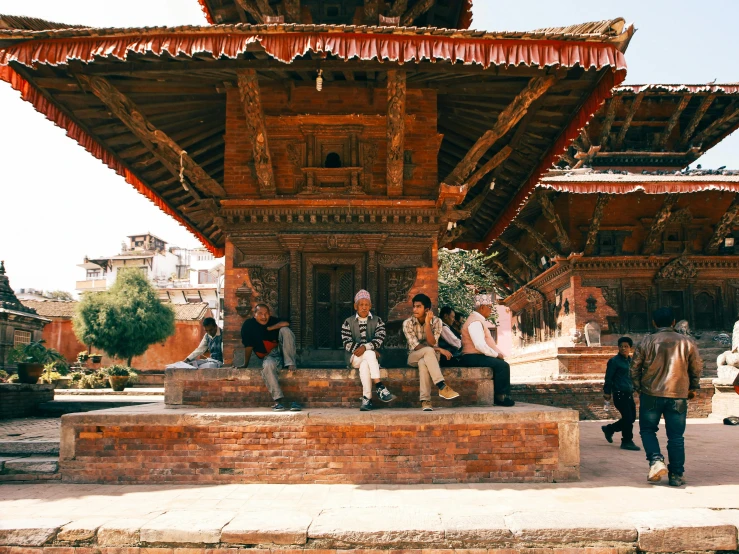 people walking around outside a building in an old town