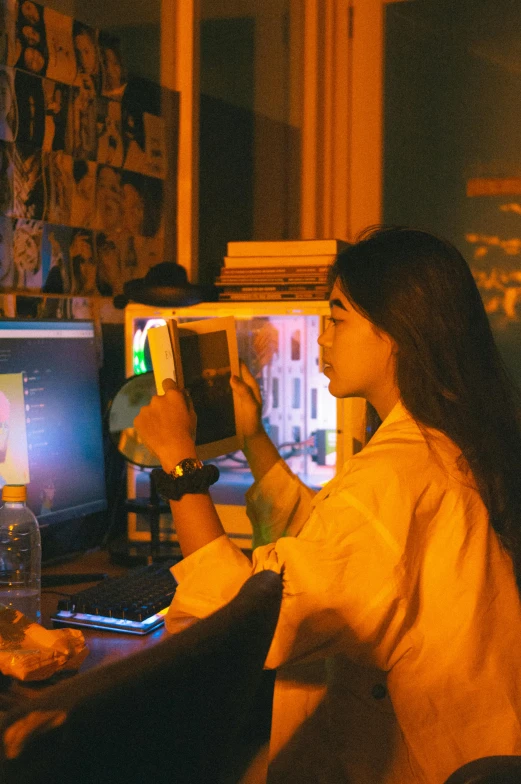 two people sitting in front of the television at a desk