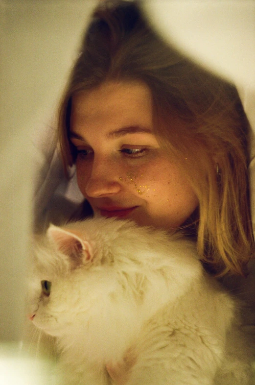 a girl holding a fluffy white cat