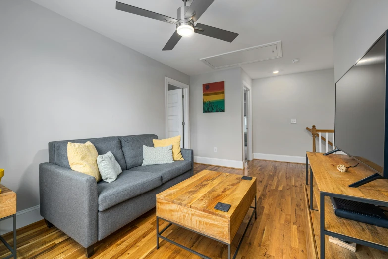 living room with gray couch and yellow throw pillows