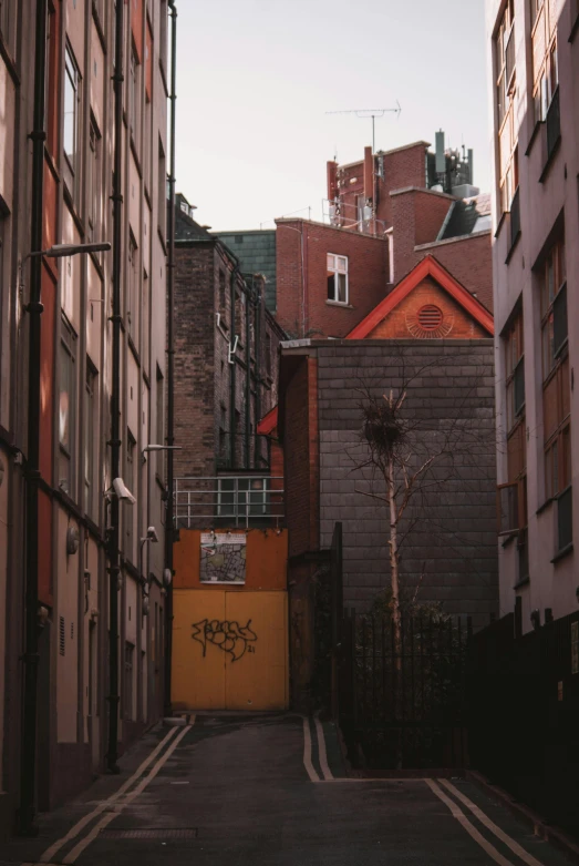 alley way with graffiti written on the building