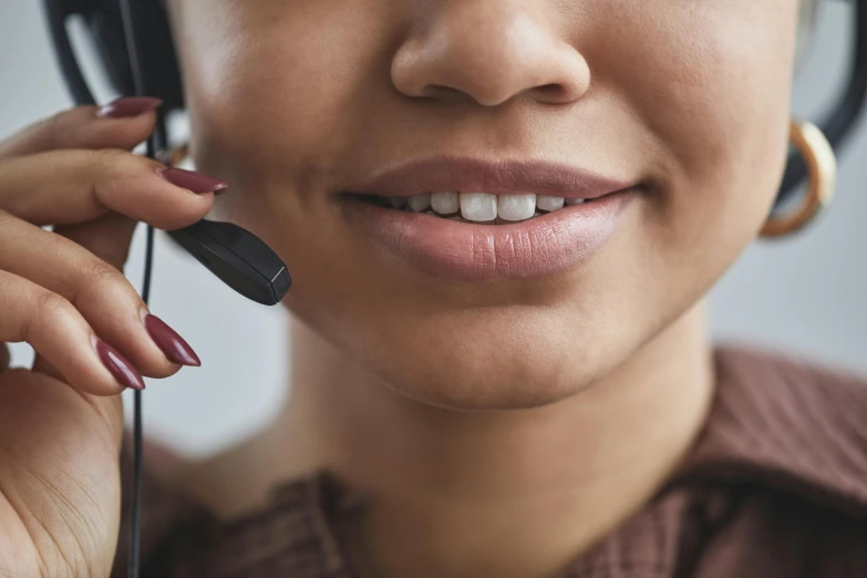 a close up of a woman talking on a telephone
