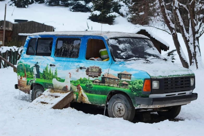 a painted van in the snow with a forest scene