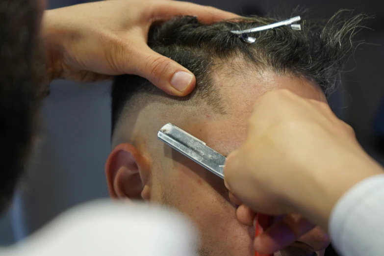 a man with some scissors  his hair