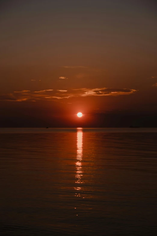 the sun setting over the ocean at dusk