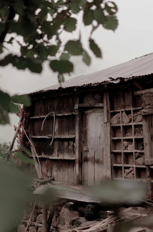 a wooden shed with a chair sitting on top of it