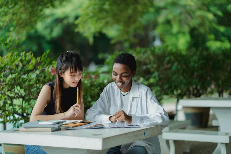 a woman is working on an assignment with a student