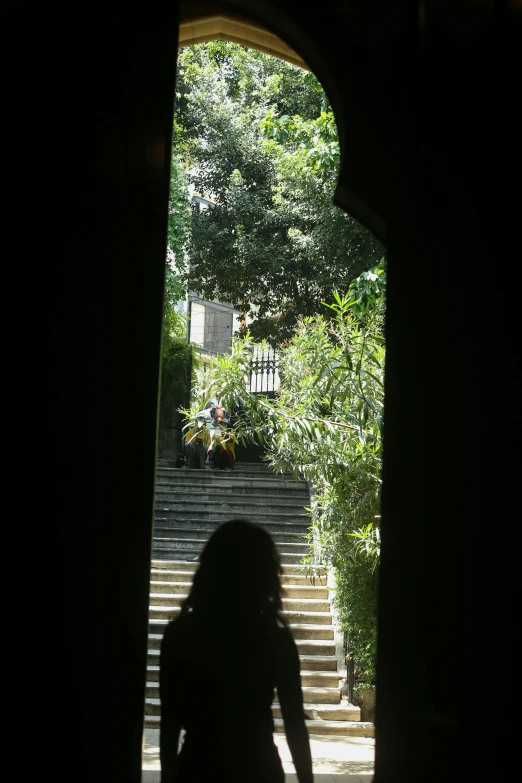 a girl is walking up the stairs in front of her house