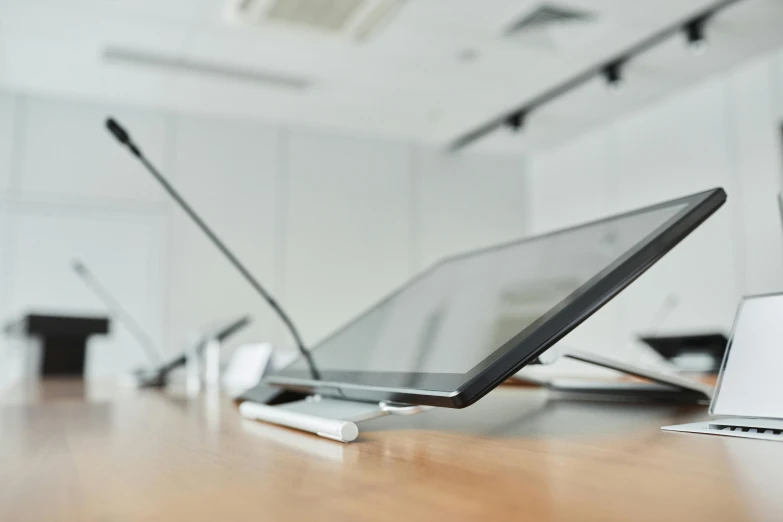 three laptops sit on the table in front of each other