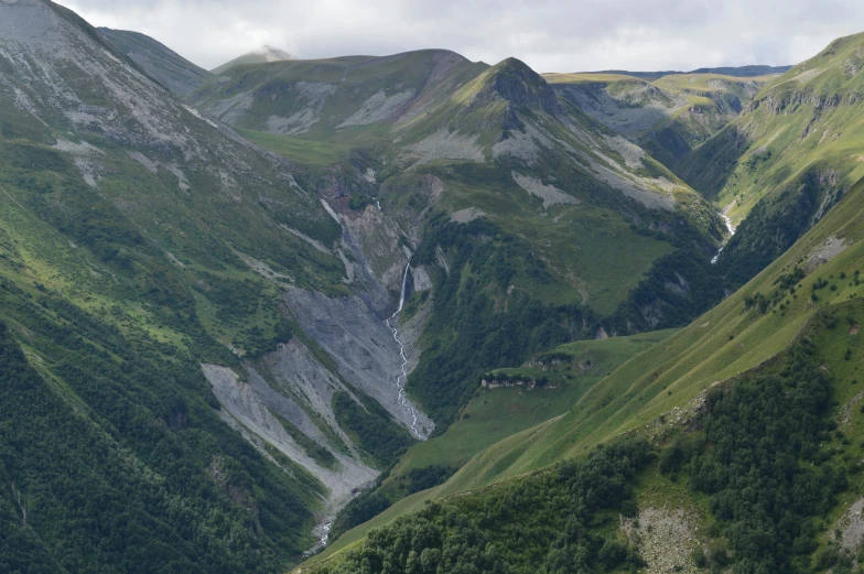 the mountains are very tall and green near each other