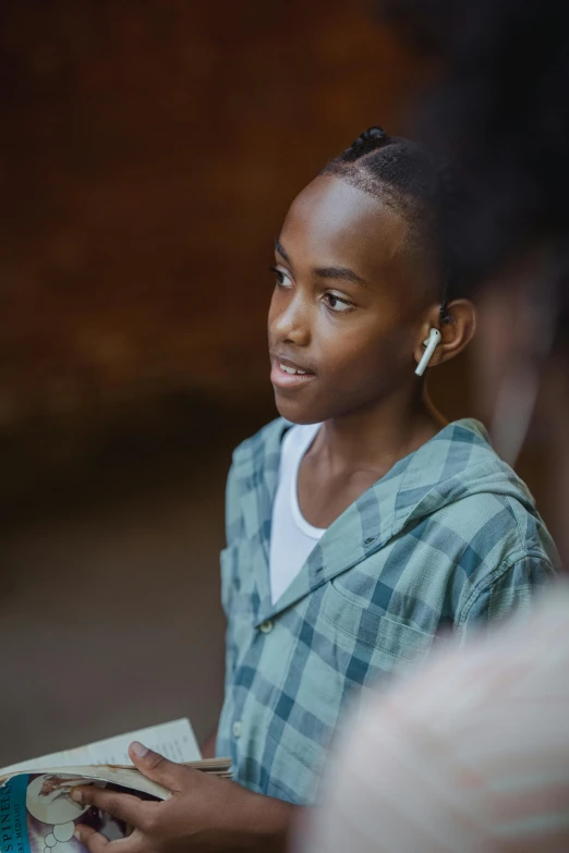 a woman standing in front of people reading