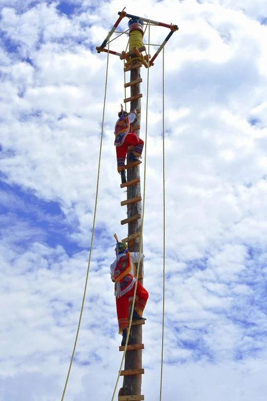 a wooden pole that has a bunch of ropes attached to it