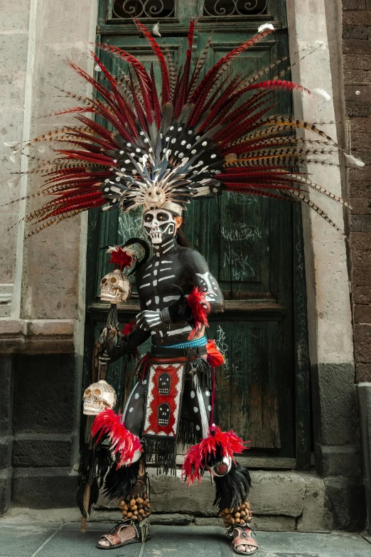 a mexican man is standing in front of a door