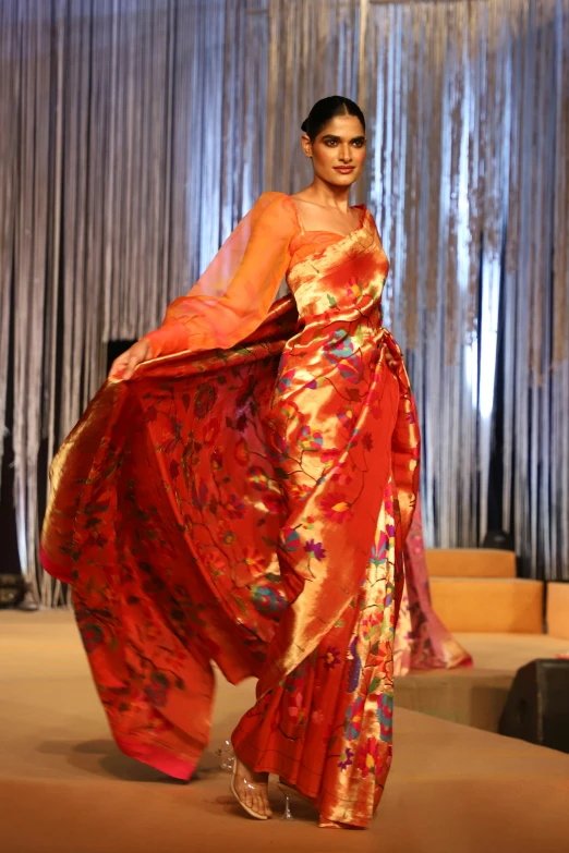 a young lady is walking in an asian dress