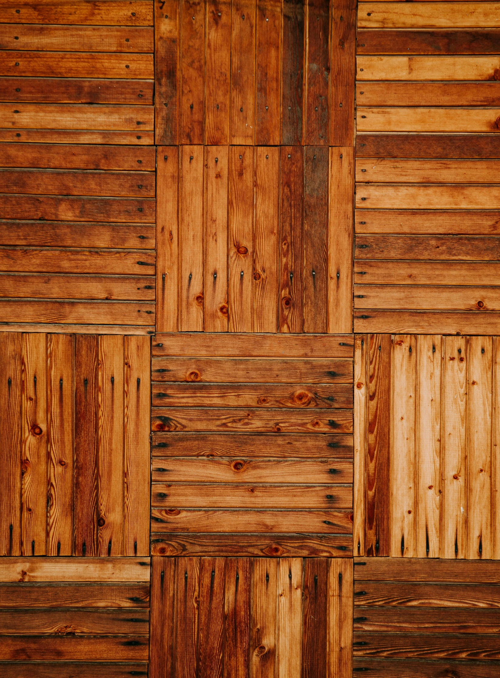 a wall with wooden boards, some brown in color