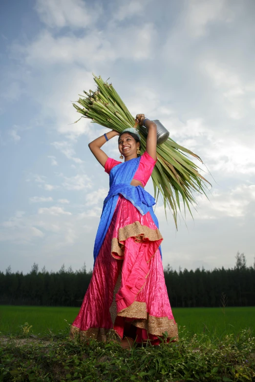 the woman is standing in the grass with grass