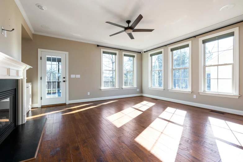 a large empty room with two big windows