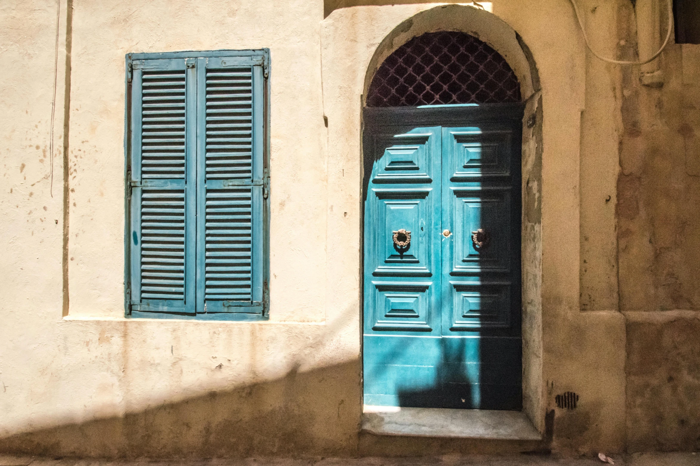 the blue door and shutters have closed up