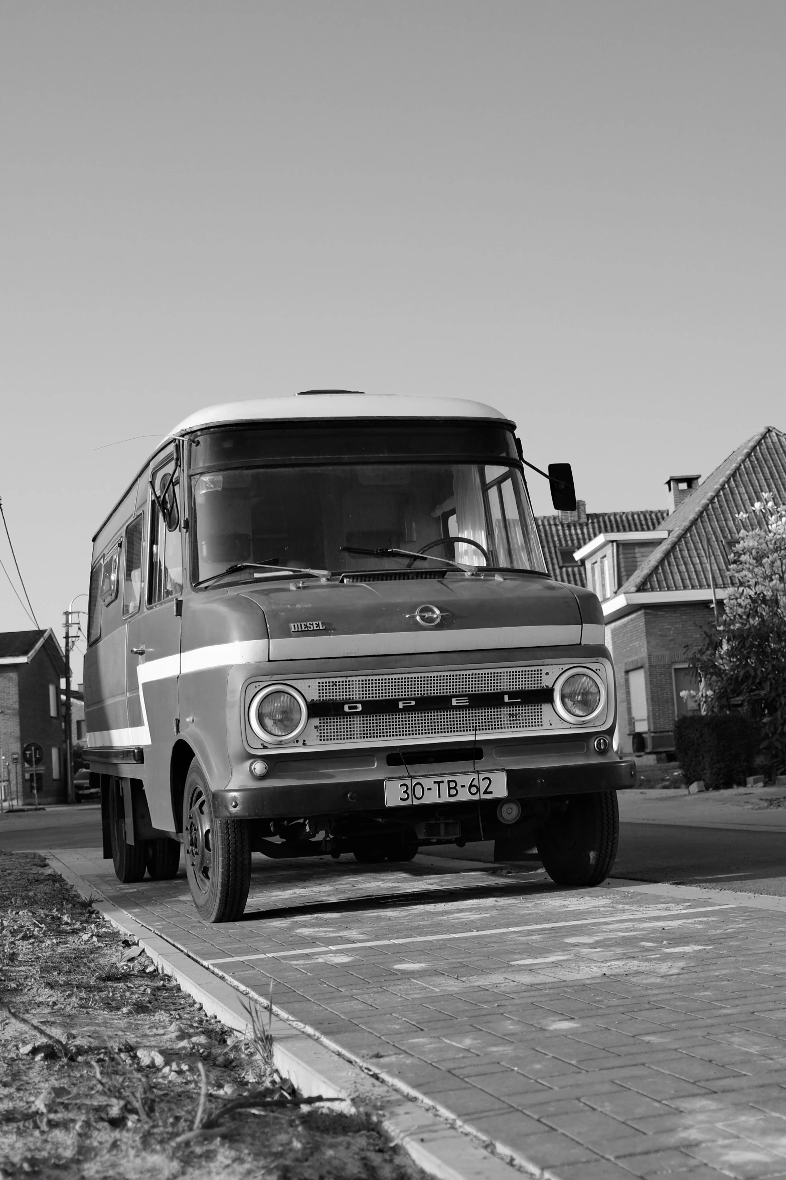 a black and white po of a large bus on the road