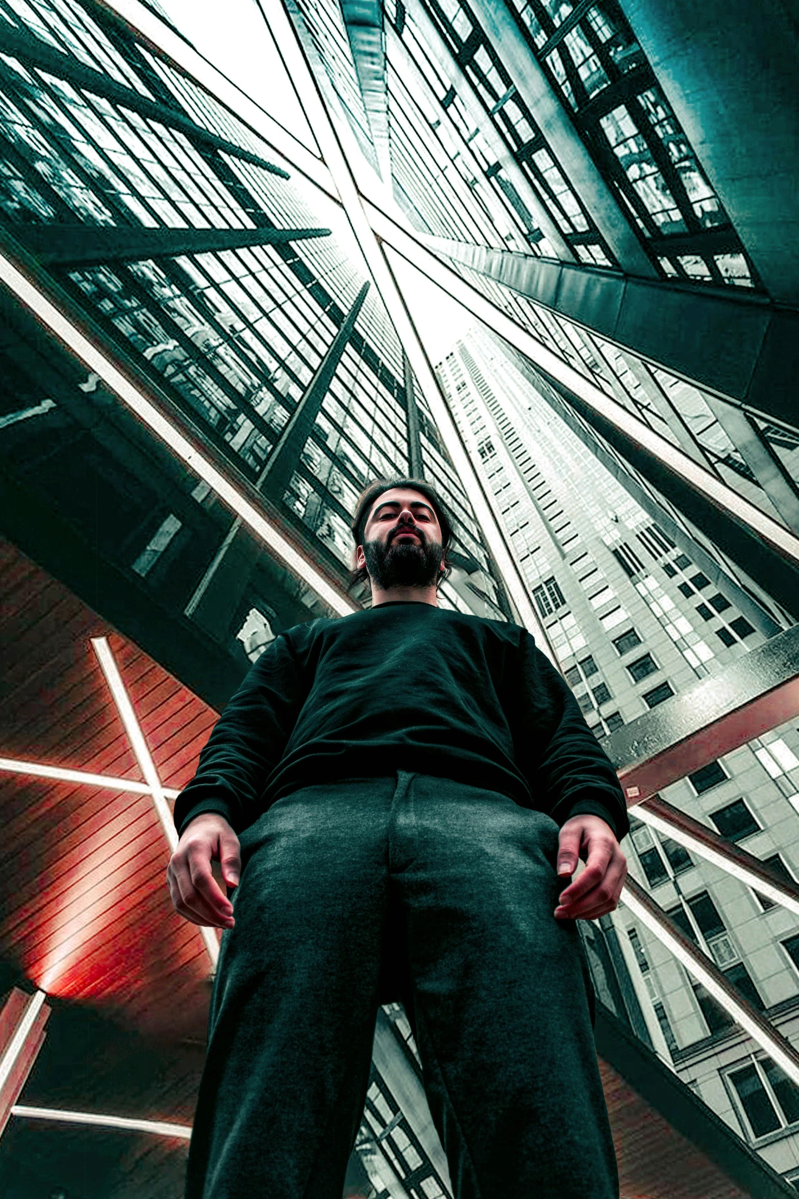 a man standing on the street underneath an office building