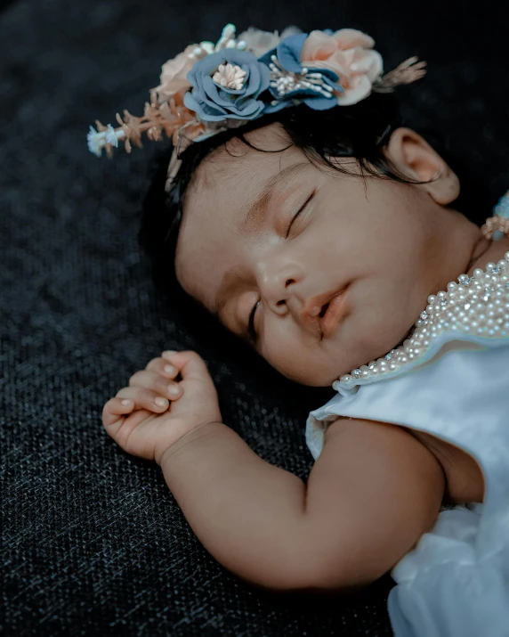 baby girl sleeping with headband and body jewelry