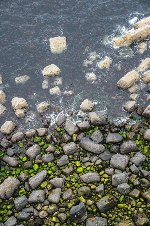 a view of the shore and rocks from above