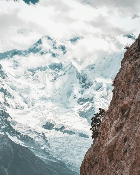 there is a man that is standing on the side of a mountain