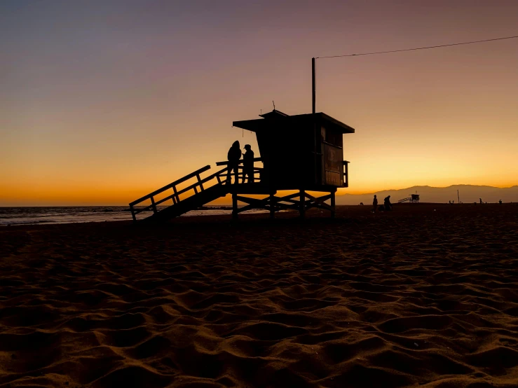 a life guard tower in the sand at the beach