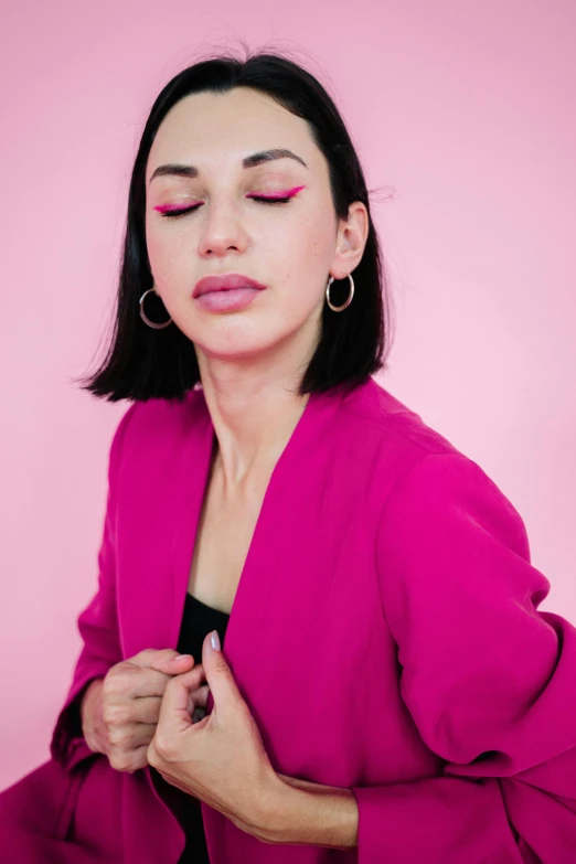 a woman is posing for the camera with her eyes closed and lipstick in her mouth