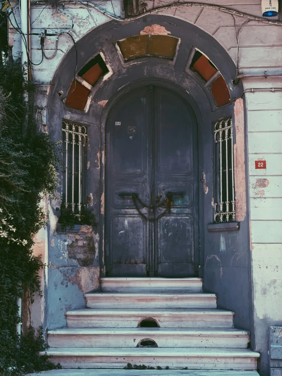 a doorway with steps going into it and a clock on the wall