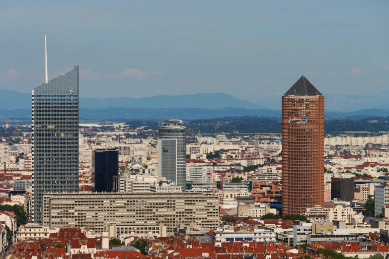 the top of two skyscrs stand tall on the city