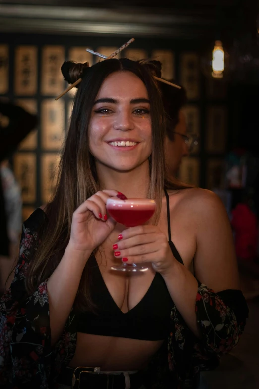 a young lady holding a drink with her hands