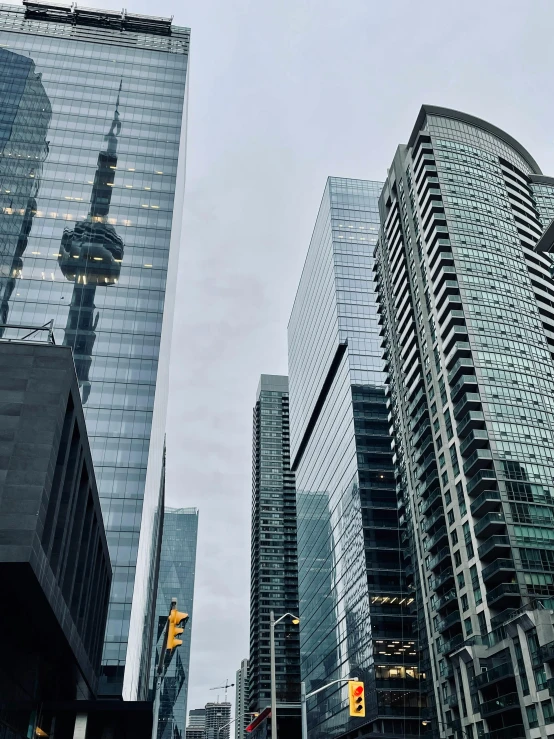 a city with skyscrs and traffic signals in a cloudy sky