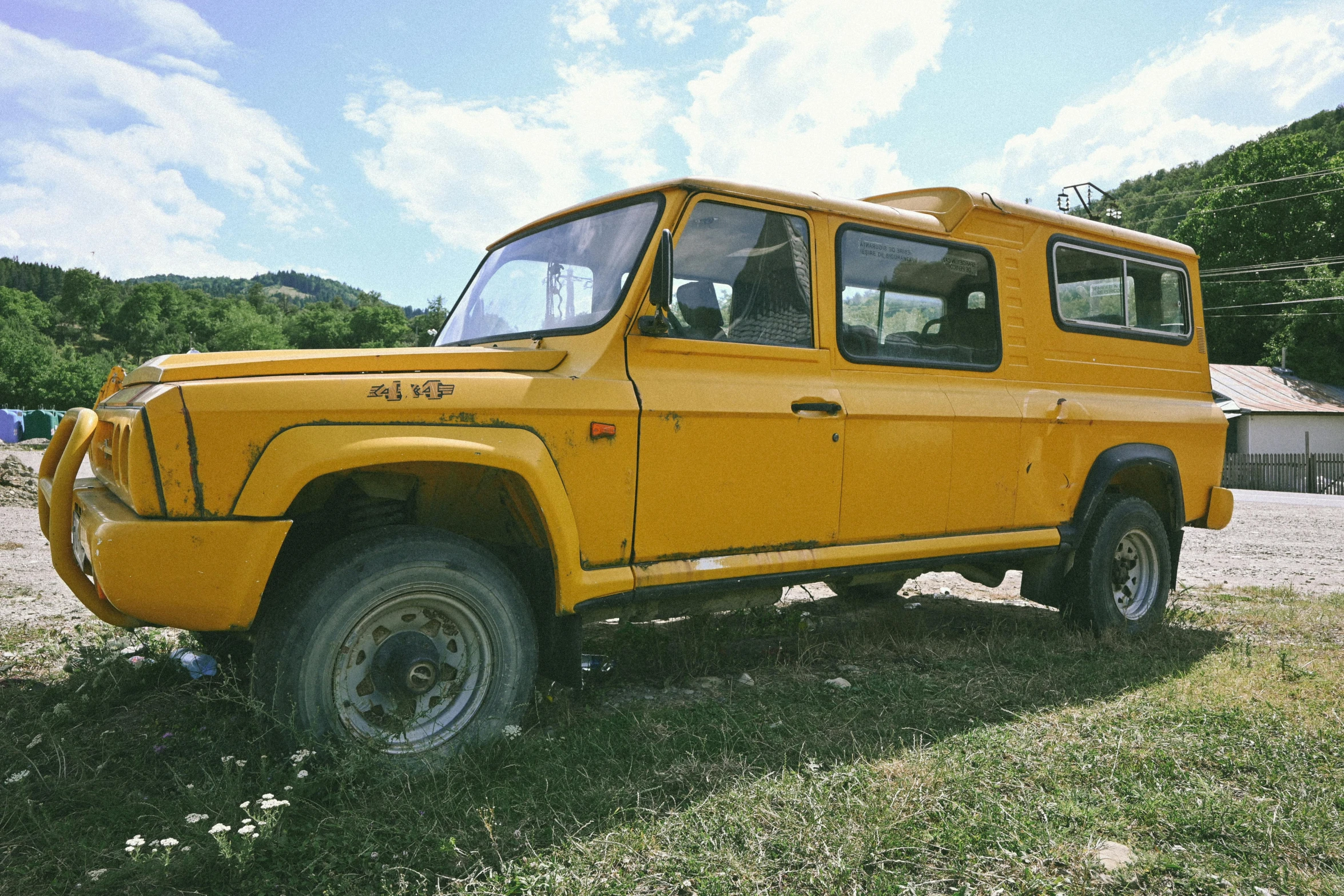 the vehicle is parked in a field on grass