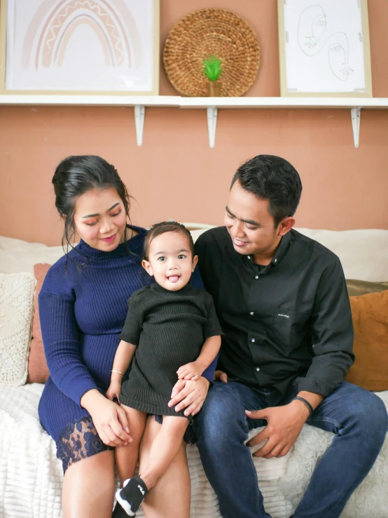 a family poses for a portrait on a couch