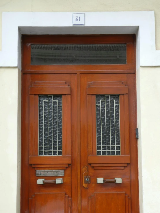 a pair of wooden doors that have glass on top