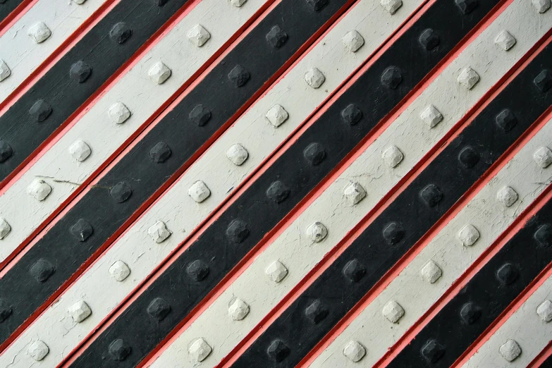 close up s of white and black pattern with red stripe