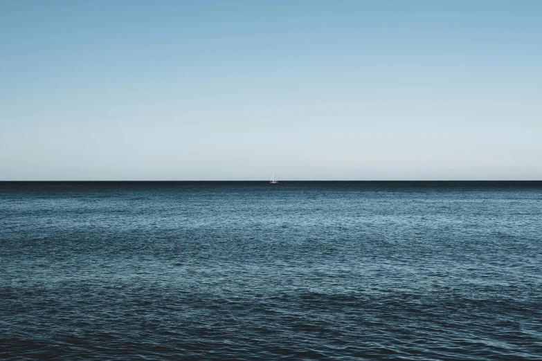 the sea and sailboat are out in the distance