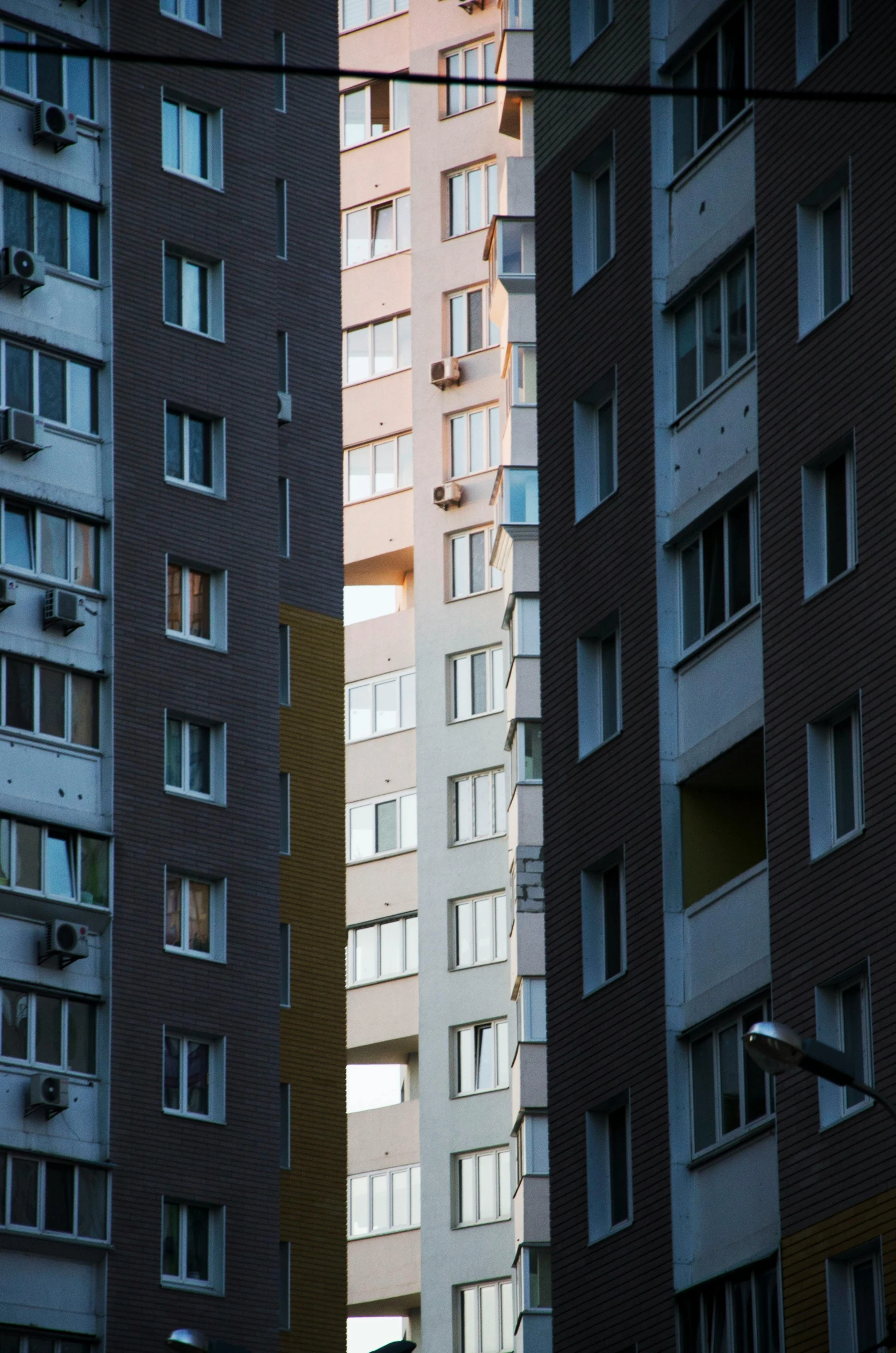 a city building with different colored windows next to one another