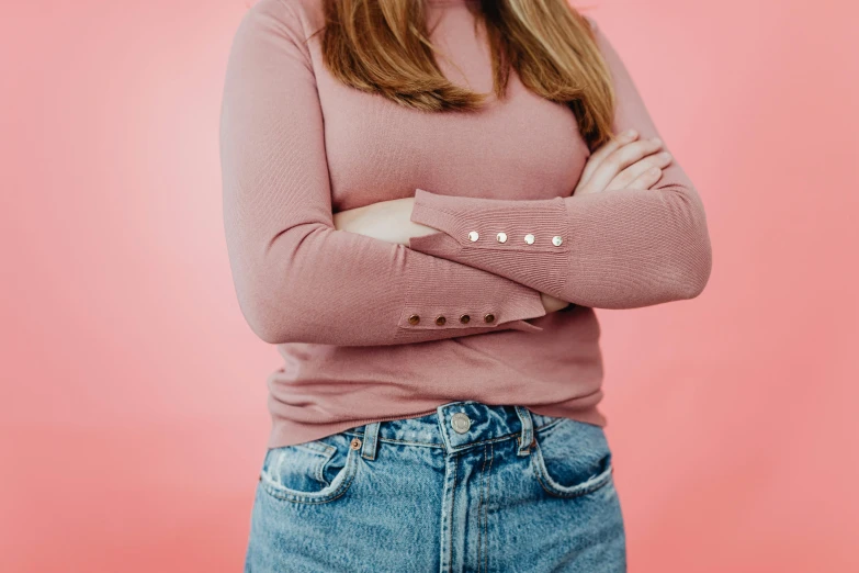 a woman with her arms crossed posing for a po