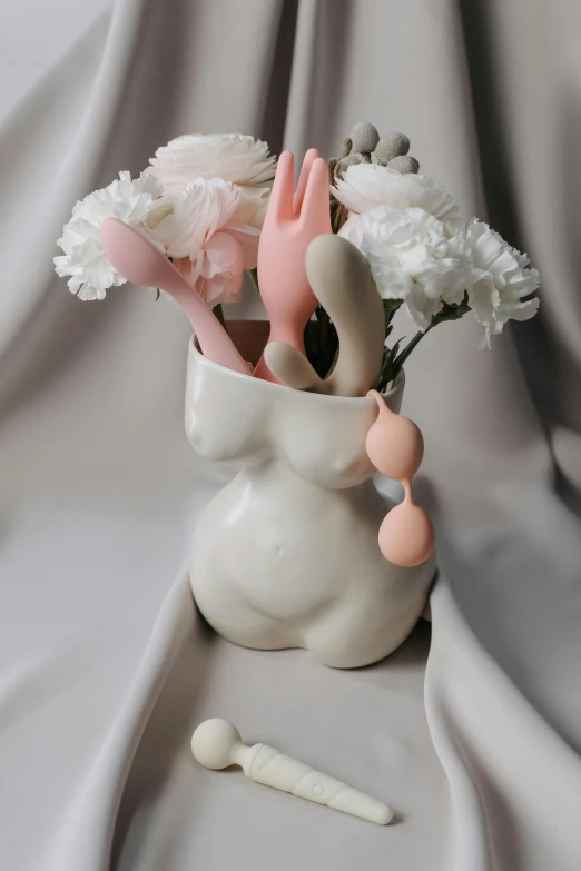 pink and white objects are in a vase