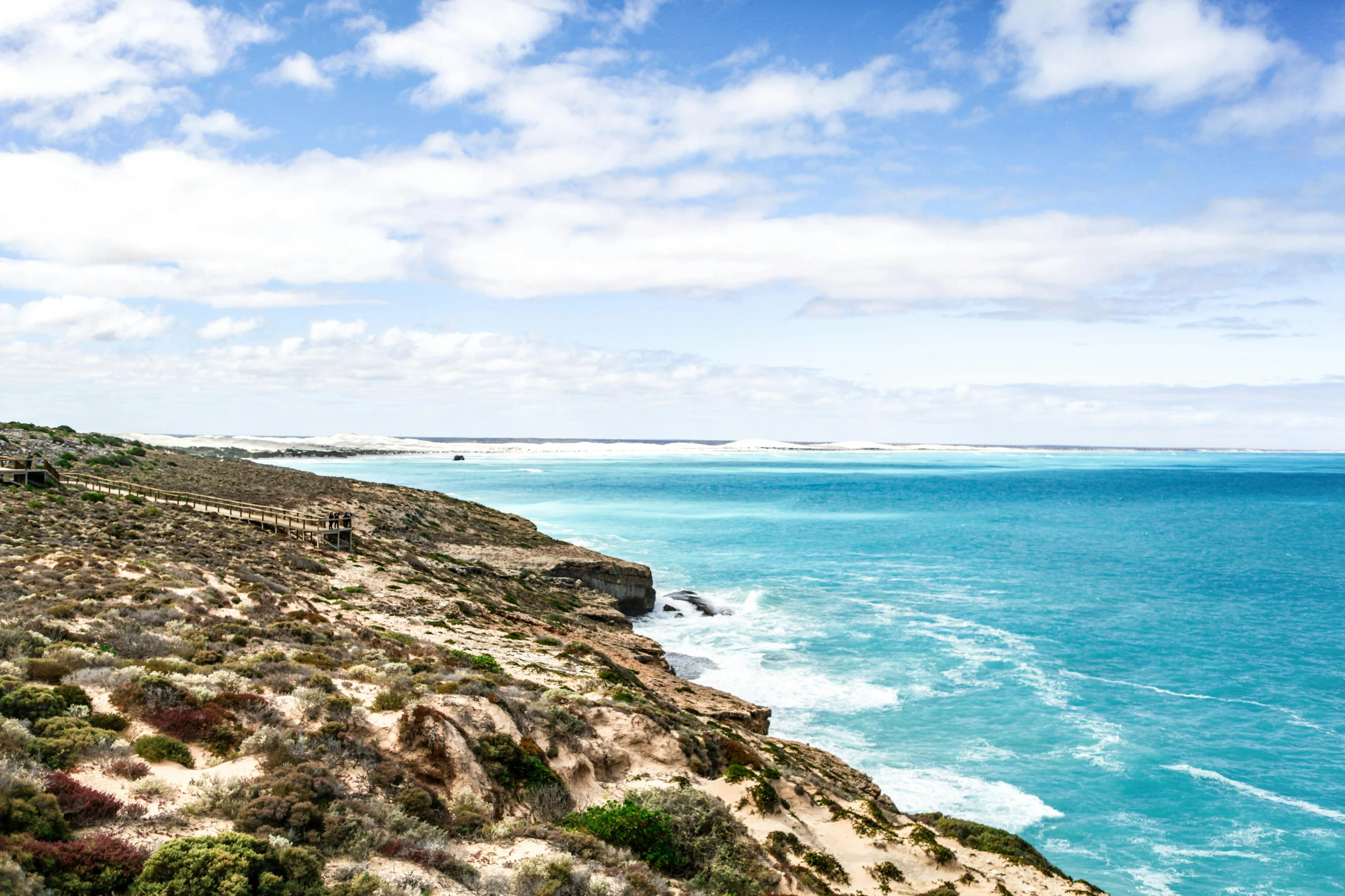 the view over the ocean and sand dunes