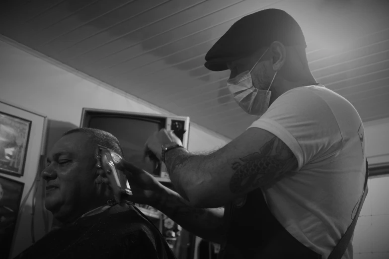 a man is getting his haircut by a person