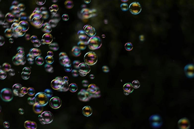 many bubbles floating on the ground in the sky