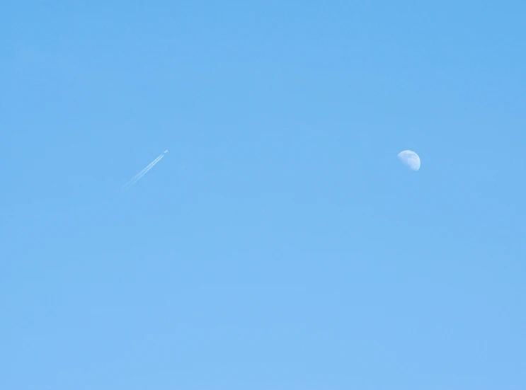 a kite is flying in the blue sky