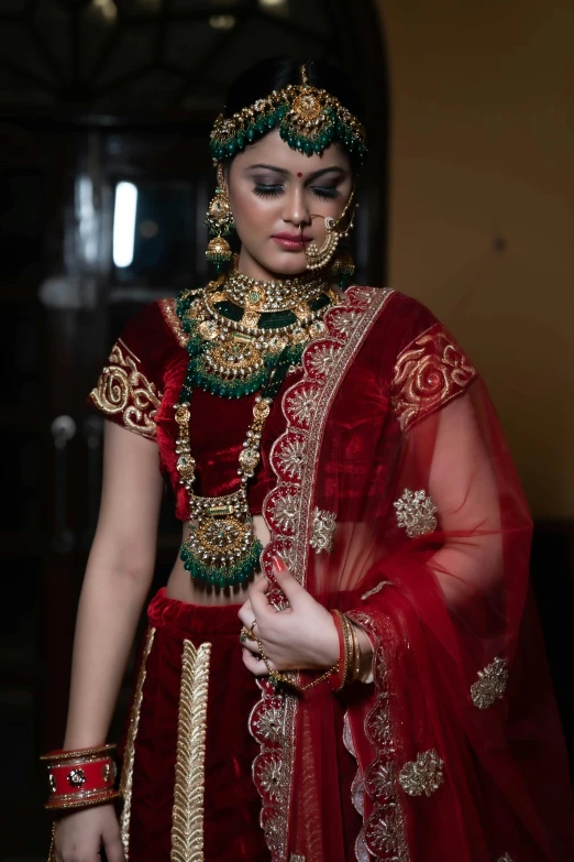 a woman dressed in a traditional outfit stands near a doorway