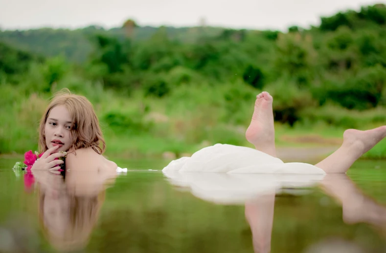 a little girl floating on top of a lake